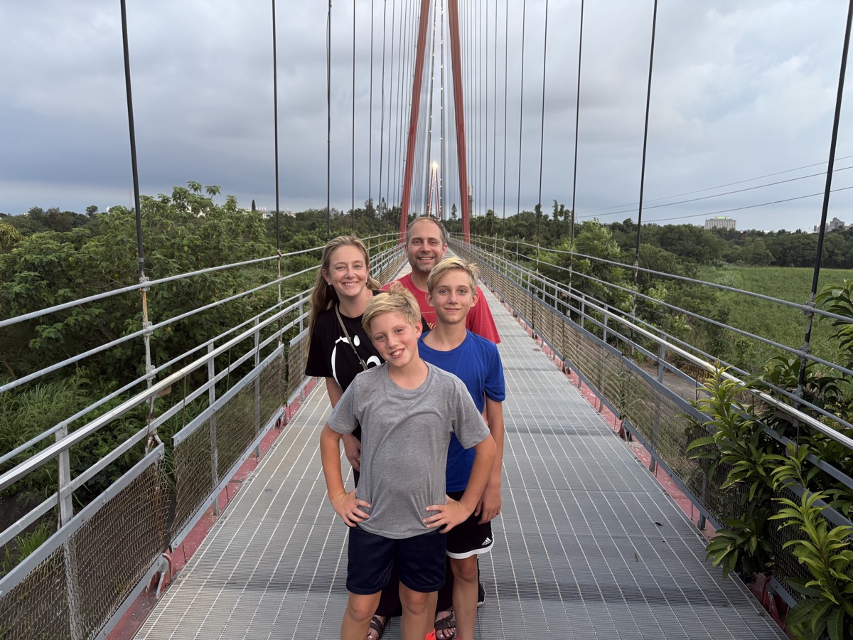 Erich Schindler with his wife and two sons on a pedestrian suspension bridge in Beigang, Taiwan.